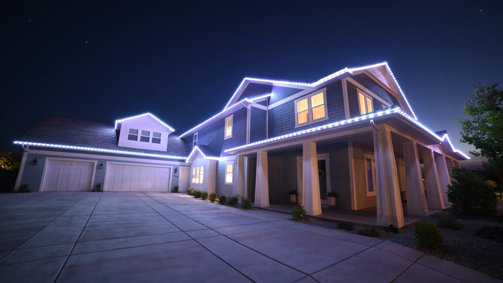 Home with cool white roofline lighting
