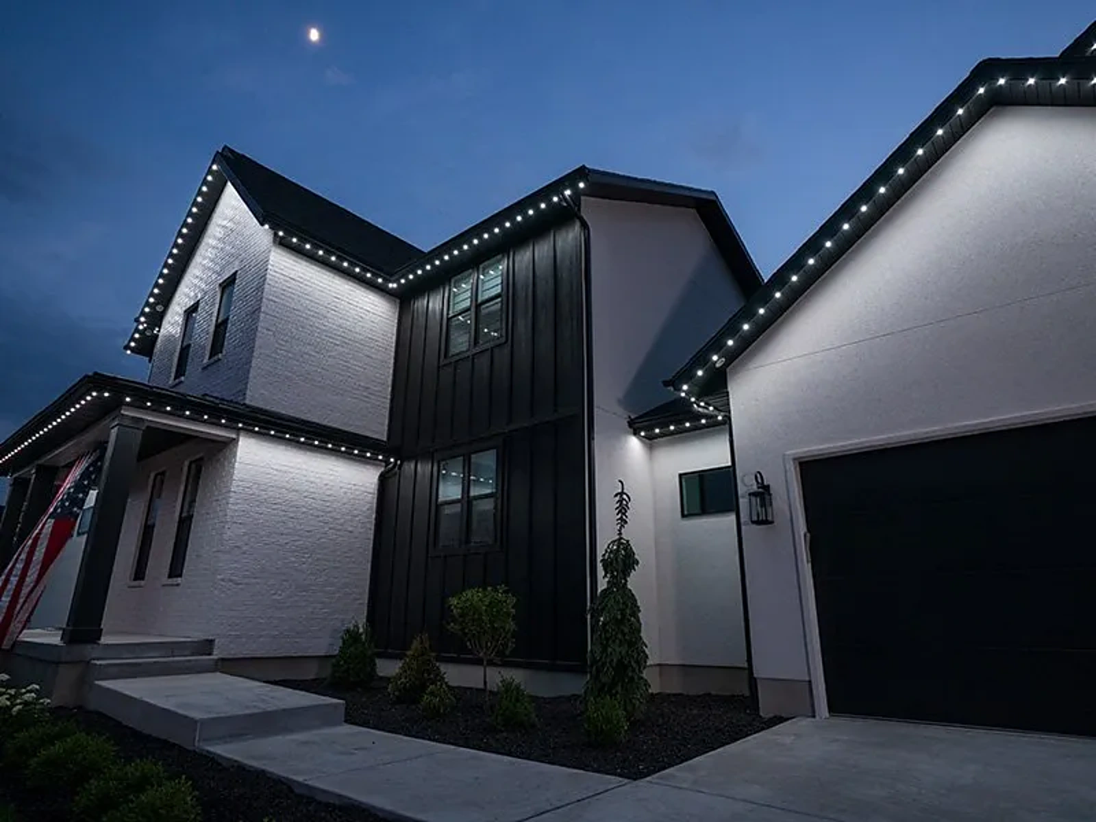 Modern farmhouse with white roofline lighting